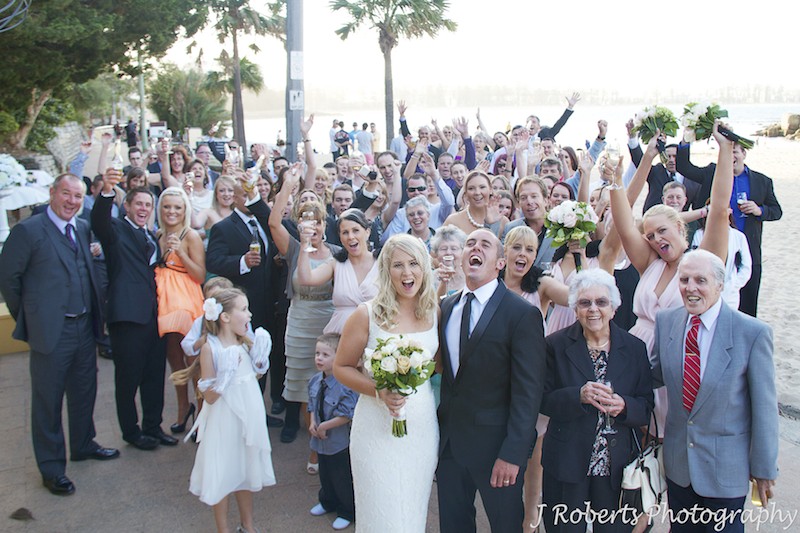 All guests cheer for couple - wedding photography sydney